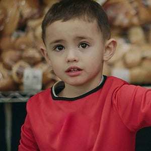Boy in front of bakery