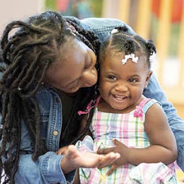 African American mother playing with her toddler daughter