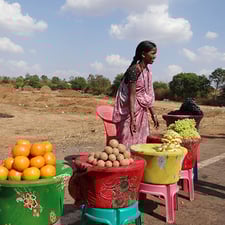 Photo of a woman at fruit stand - SmartSimple's dedicated technical community support