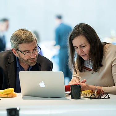 Photo of people working on laptop - SmartSimple was the best system for Harrington Discovery Institute