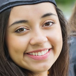 Photo of a smiling female student graduating from university