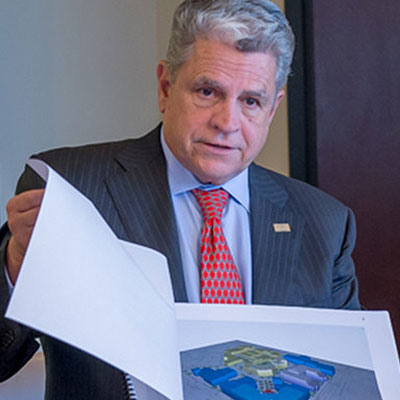 The Founding Chairman of Helios Education Foundation shows a project diagram in a meeting