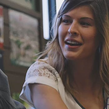 A young woman smiling and collaborating at an office meeting