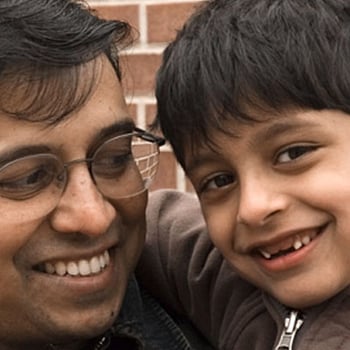 South Asian father and son smiling