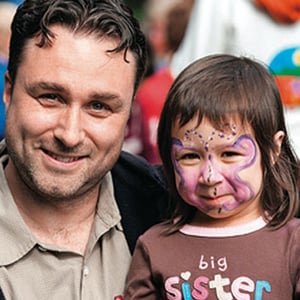 Father and young daughter - daughter with painted face