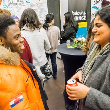 A man and a woman conversing at an event