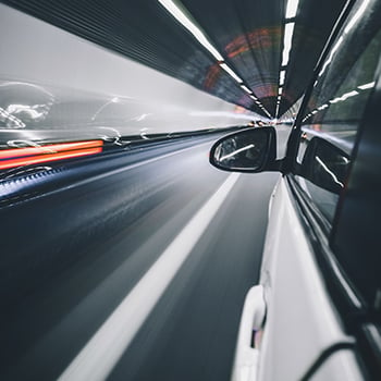 Photo of car driving through a tunnel
