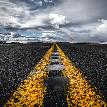 Close up of a remote highway's yellow lines