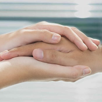 Close up of hands holding hand