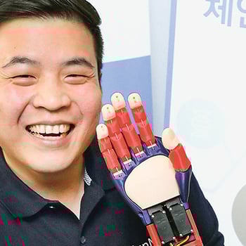 An Asian man smiling